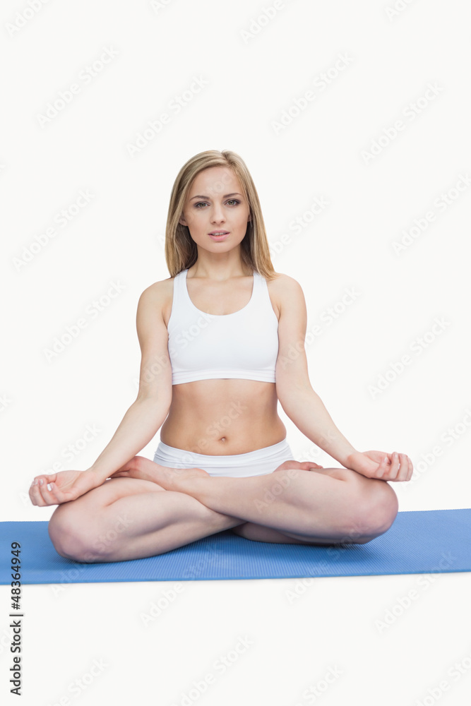 Portrait of young woman sitting in lotus position Portrait of young woman sitting in lotus position