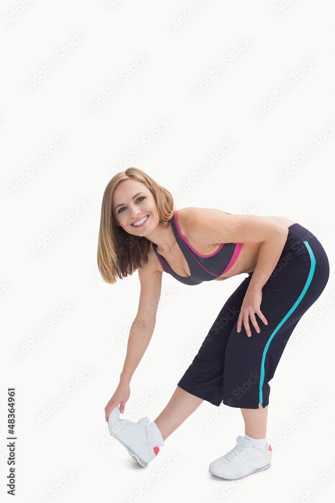 Portrait of young woman doing stretching exercise