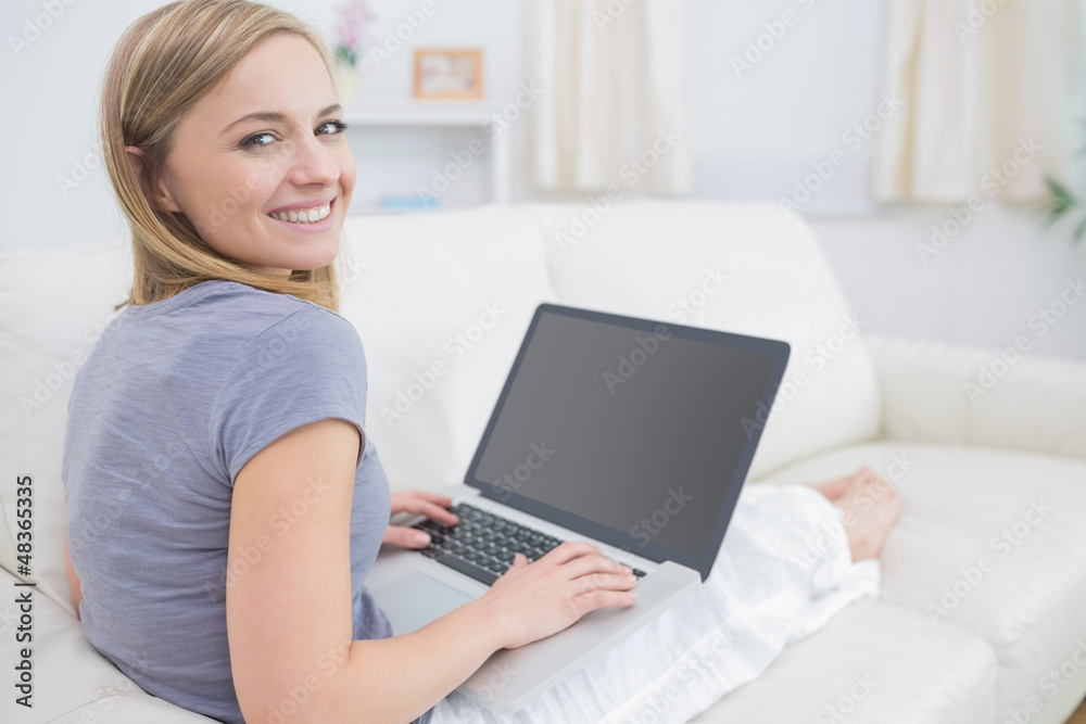 Portrait of casual woman using laptop in living room Portrait of casual woman using laptop in living room
