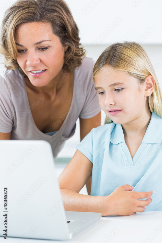 Mother and daughter using the laptop Mother and daughter using the laptop