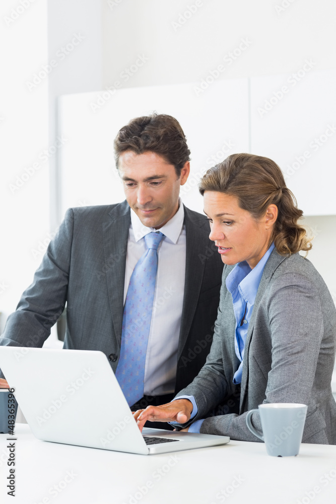 Couple looking at laptop before work Couple looking at laptop before work