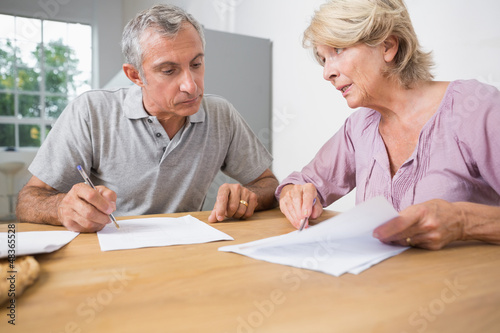 Couple discussing with documents