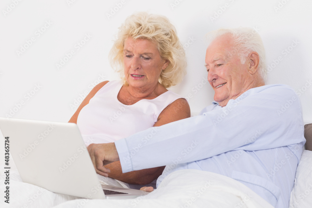 Aged couple using a laptop Aged couple using a laptop