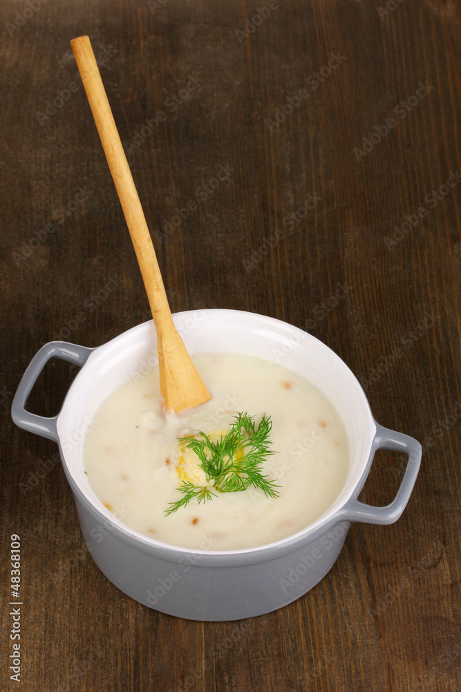 Mashed potatoes in saucepan on wooden table Mashed potatoes in saucepan on wooden table