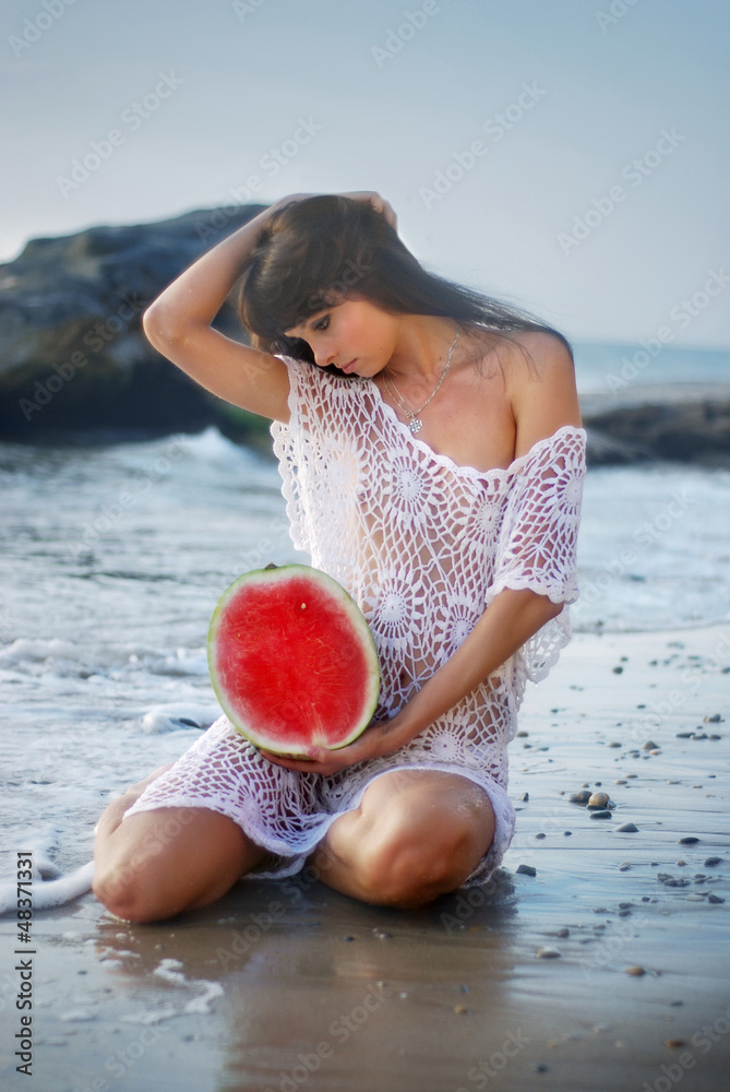 Sexy girl with dark hair eating watermelon Stock Photo | Adobe Stock