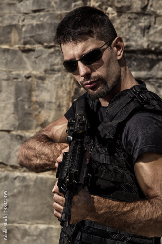 menacing man with a machine gun