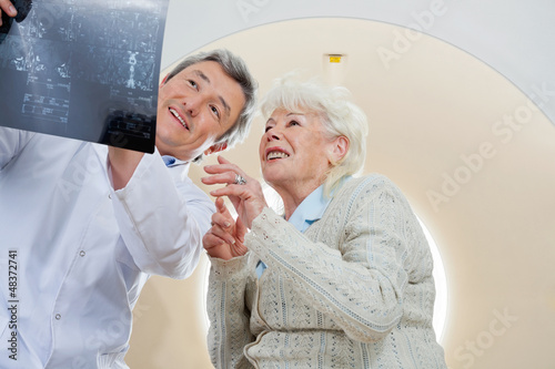 Doctor With Patient Looking At MRI X-ray