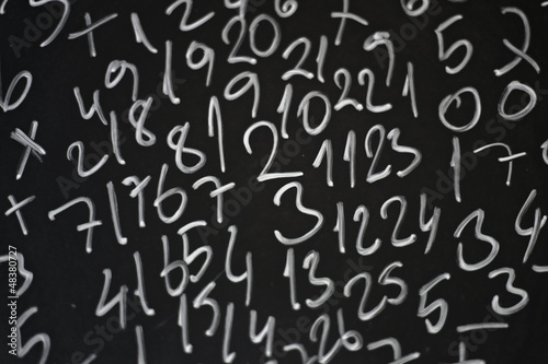 Random numbers written in chalk on a blackboard