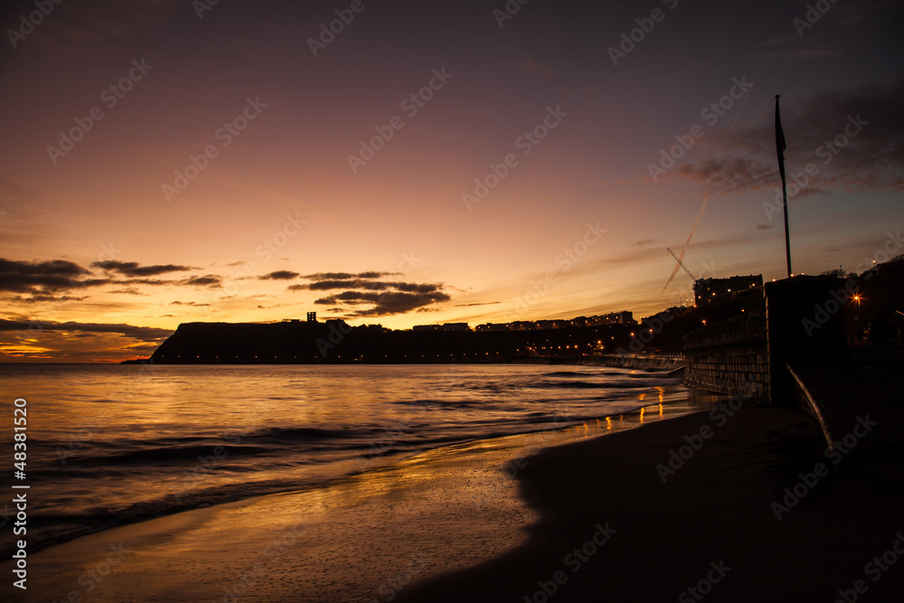 Sunrise on Scarbourgh's North Beach with the castle Silhouetted