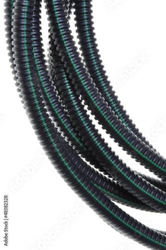 Black corrugated pipe with a green line for electrical cables