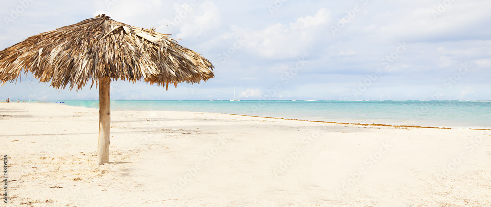 Beach umbrella on exotic caribbean plage.