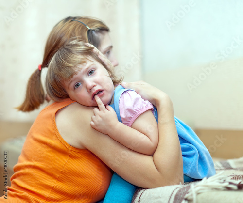 Vászonkép woman soothes crying child