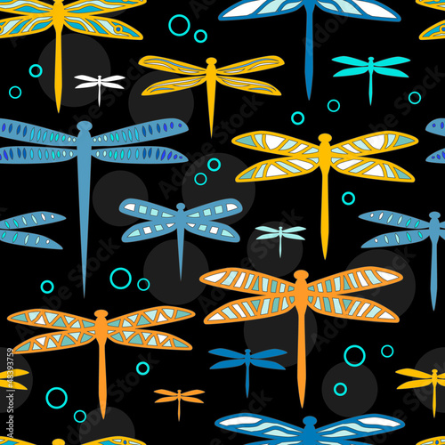 Colorful dragonflies on bla...