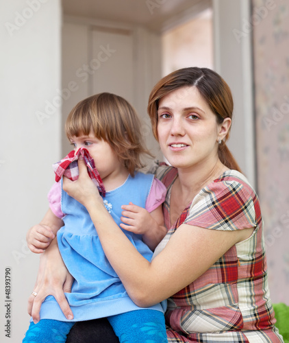 woman wipes snivels daughter photo