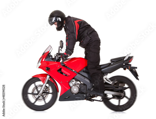 Biker standing up while riding his motorbike