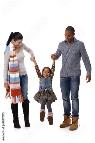 Mixed race family with cute little girl walking