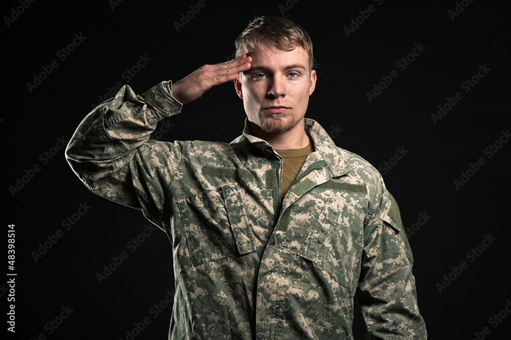 Military young man salutes. Studio portrait. Military young man salutes. Studio portrait.