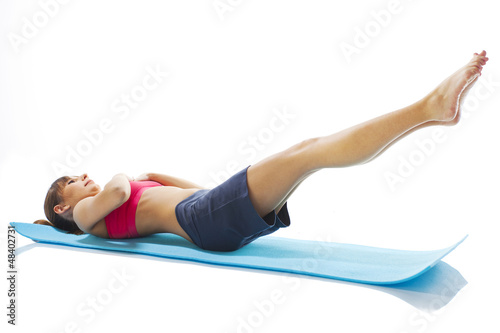young fitness woman doing pilates exercise