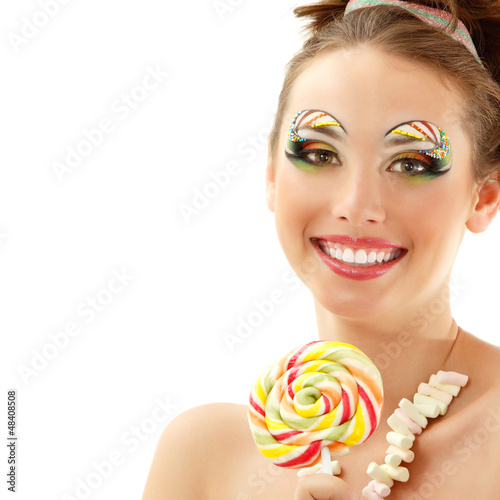 woman laughing with candy and beautiful make-up young attractive photo