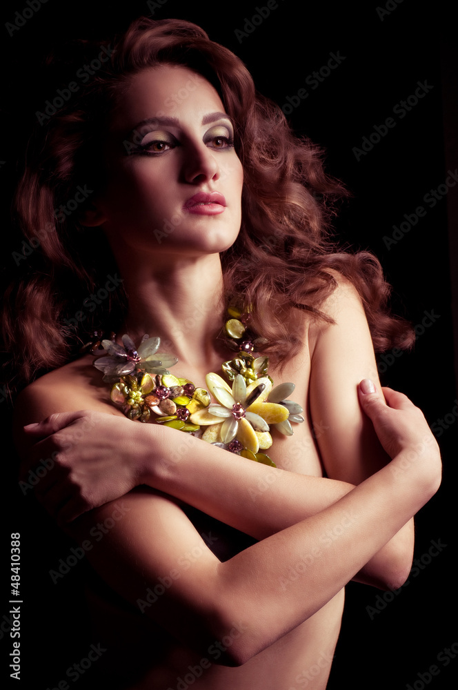 woman with makeup in luxury green necklace woman with makeup in luxury green necklace