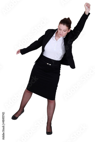 A businesswoman raising her fist to the sky.