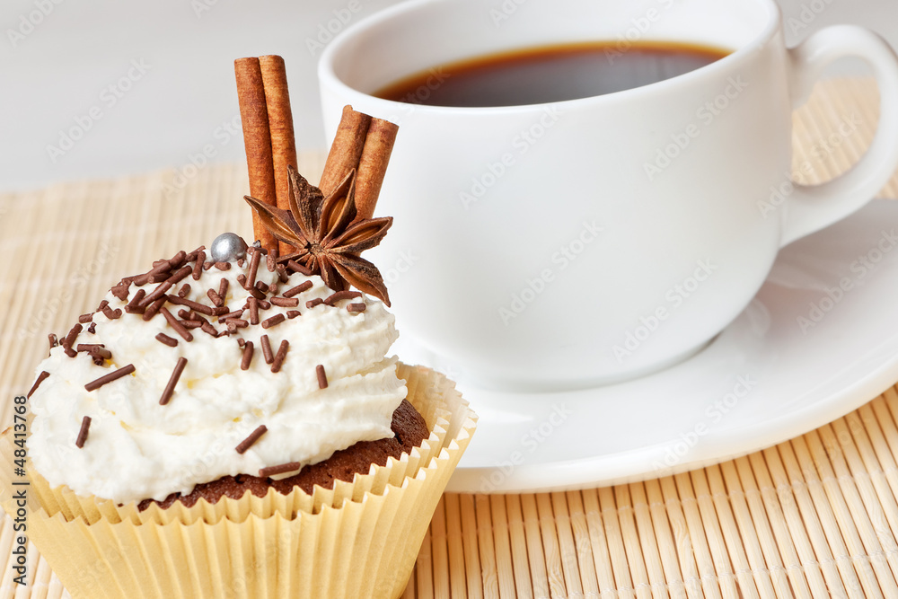 chocolate cake with whipped cream, decorated anise and cinnamon