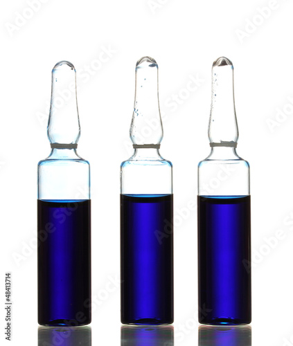 medical ampules with blue liquid, isolated on white