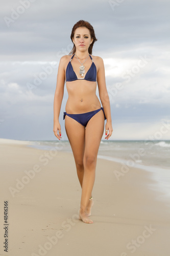 beautiful girl walking in the beach