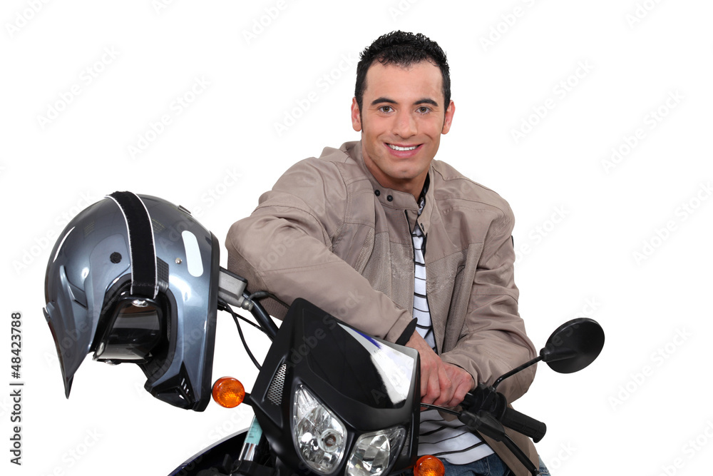 Smiling man sitting on a motorbike