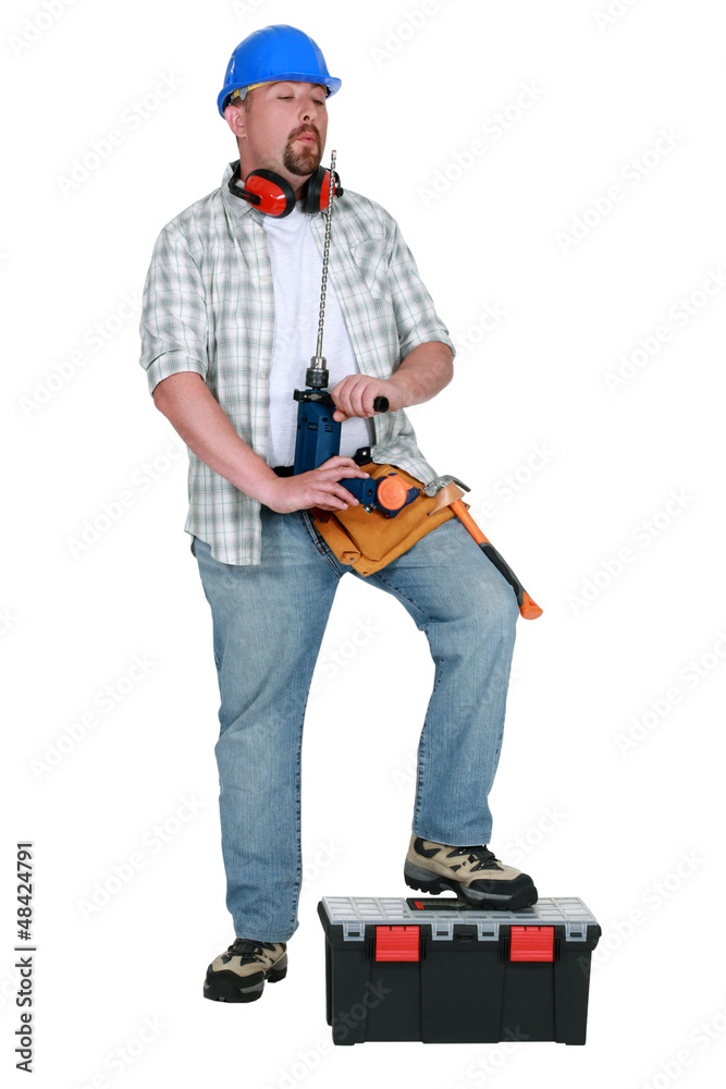 Tradesman blowing on his screwdriver Tradesman blowing on his screwdriver