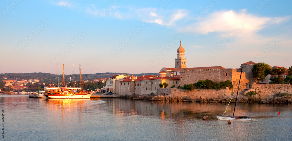 Naklejka premium Panoramic view of Krk port and city walls from the sea - Croatia