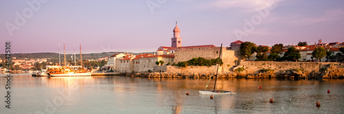Panoramic view of Krk port and city walls from the sea with morn photo