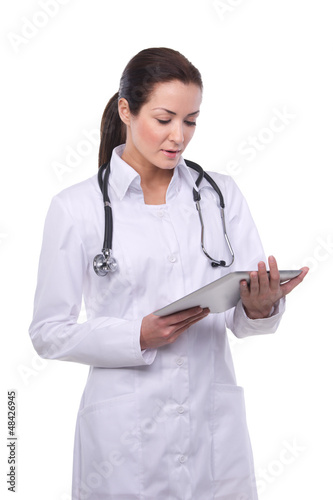 Beautiful brunette female doctor using a digital tablet.Isolated