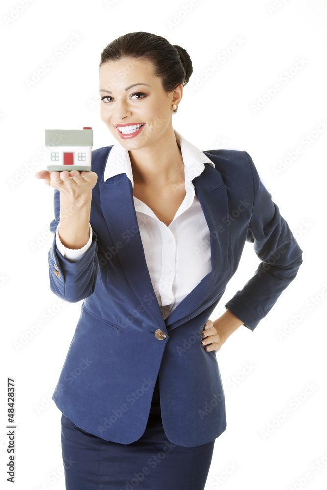 Beautiful businesswoman holding house model Beautiful businesswoman holding house model