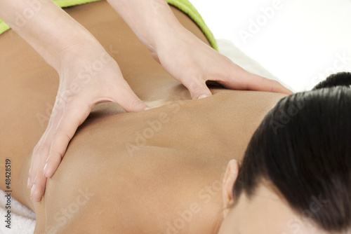 Young woman relaxing beeing massaged in spa saloon