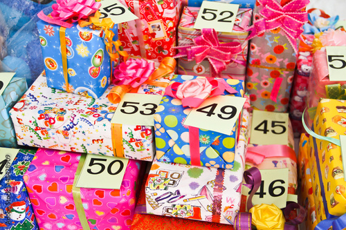 pile of Christmas gifts in colorful wrapping with ribbons agains © jukree