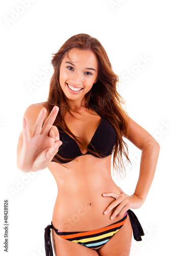 Beautiful bikini woman showing Ok sign