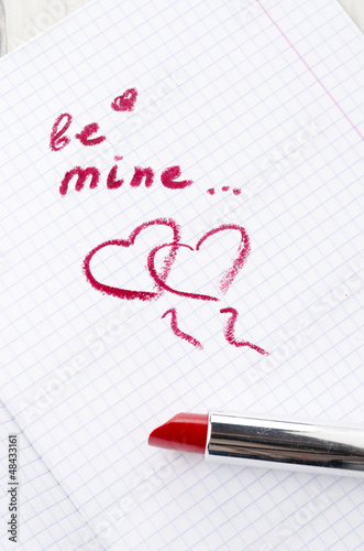 Sign on heart in a notebook and lipstick in Valentine's Day