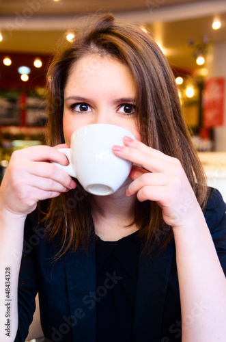 woman is drinking coffee