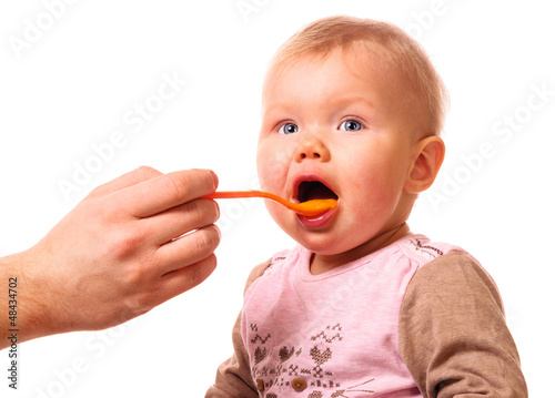 man is feeding his baby