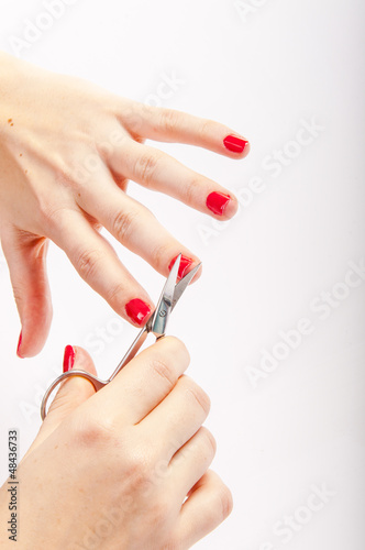 Female nails and scissors