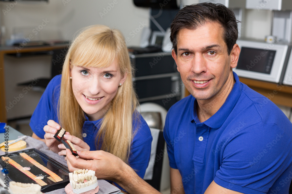 Two dental technicians choosing the right colour