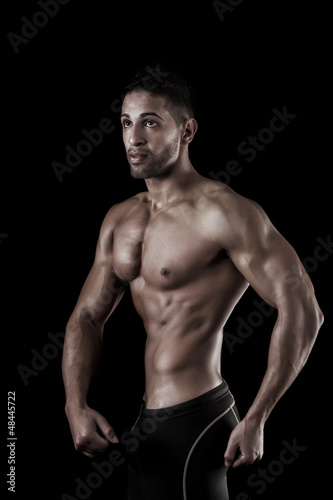 muscled man on a black background