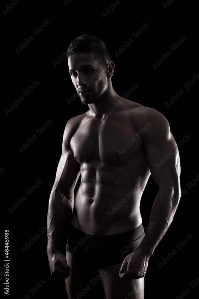muscled man on a black background muscled man on a black background