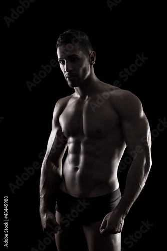 muscled man on a black background