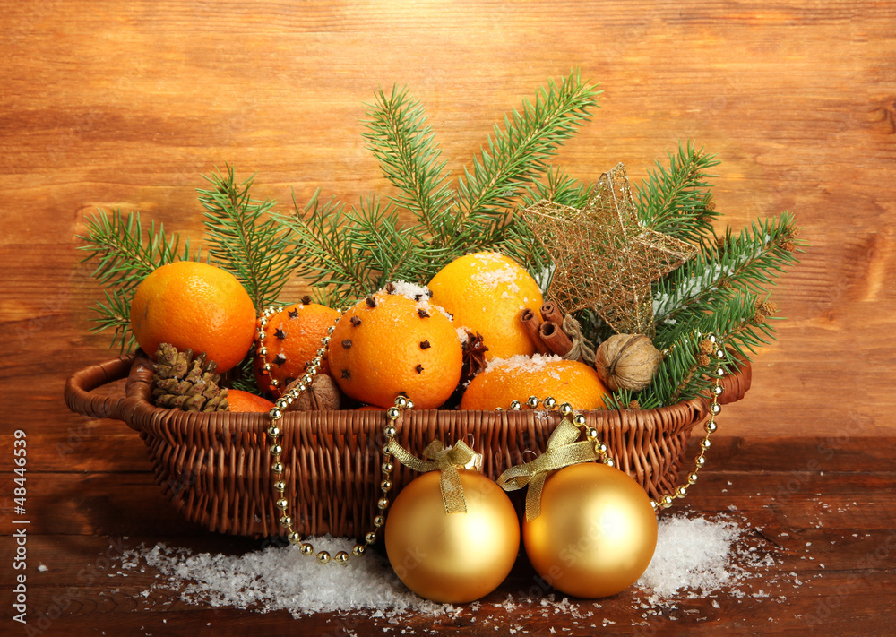 christmas composition in basket with oranges and fir tree,