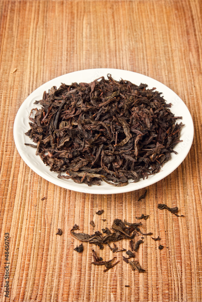 Chinese tea leaves on plate over grunge background Chinese tea leaves on plate over grunge background