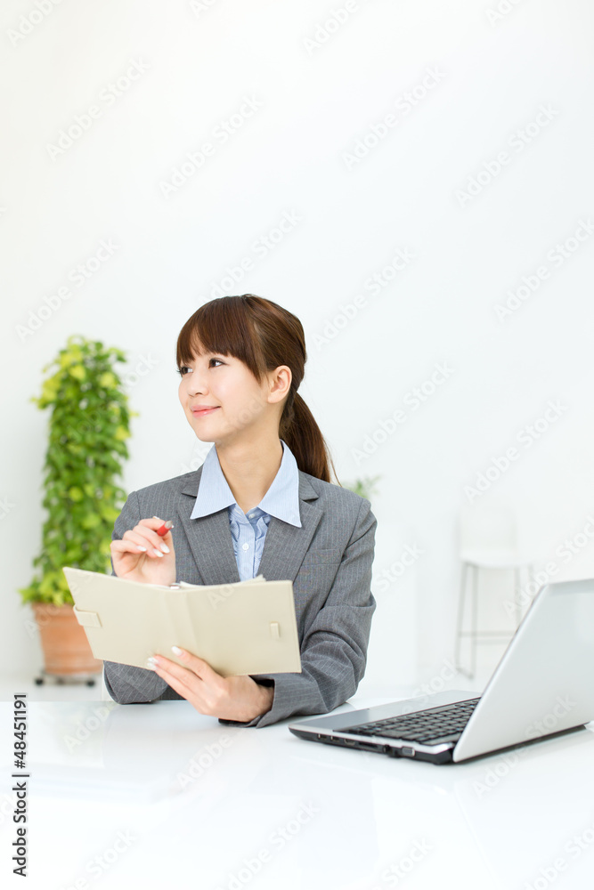 Beautiful young businesswoman working in office Beautiful young businesswoman working in office