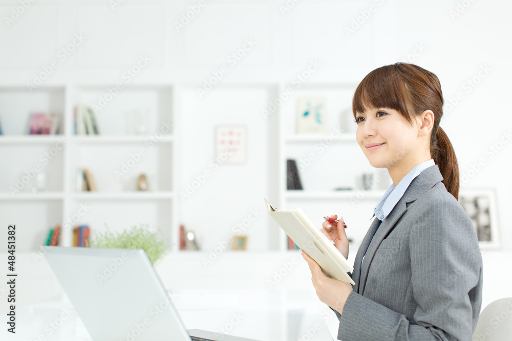 Beautiful young businesswoman working in office Beautiful young businesswoman working in office