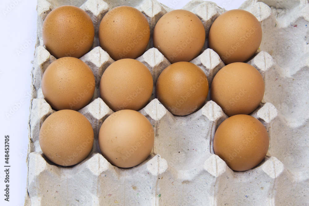 Closeup of many fresh brown eggs in carton tray Closeup of many fresh brown eggs in carton tray